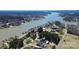 Aerial view of a lakefront property with a private dock and mature trees at 126 Anchor Ln, Troutman, NC 28166