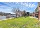 Lush green backyard leading to a private beach and dock on the lake at 126 Anchor Ln, Troutman, NC 28166