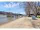 Lakeside backyard with a private beach and multiple docks for boats at 126 Anchor Ln, Troutman, NC 28166