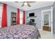 Comfortable bedroom featuring a ceiling fan, a study area, and an open doorway to a seating area at 126 Anchor Ln, Troutman, NC 28166