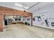 Spacious garage featuring exposed brick, ample storage space, overhead lighting and a clean concrete floor at 126 Anchor Ln, Troutman, NC 28166