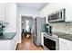 Modern kitchen with stainless steel appliances, granite countertops, and an adjacent dining area at 126 Anchor Ln, Troutman, NC 28166