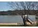 Picturesque lake view featuring a sandy beach, a private dock and a tranquil waterfront setting at 126 Anchor Ln, Troutman, NC 28166
