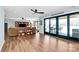 Bright living room with floor-to-ceiling sliding doors, a ceiling fan, hardwood floors, and modern decor at 126 Anchor Ln, Troutman, NC 28166
