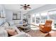 Inviting living room with waterfront views, wood floors, modern furniture, and sliding glass doors to a deck at 126 Anchor Ln, Troutman, NC 28166