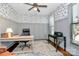 Comfortable home office featuring a ceiling fan, hardwood floors, stylish furniture and decorative wallpaper at 126 Anchor Ln, Troutman, NC 28166