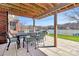 Covered patio with an outdoor dining set offering picturesque lake views at 126 Anchor Ln, Troutman, NC 28166