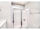 Modern bathroom featuring a glass-enclosed shower with chrome fixtures and bright, neutral decor at 12889 Hill Pine Rd, Midland, NC 28107