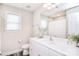 Bright bathroom featuring white vanity, modern fixtures, decorative accents, and wood-look floors at 12889 Hill Pine Rd, Midland, NC 28107