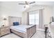 Bright bedroom with vaulted ceiling, ceiling fan, carpeted floor, and light wood furniture at 12889 Hill Pine Rd, Midland, NC 28107