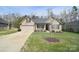 Charming brick home featuring an attached two-car garage and well-maintained lawn at 12889 Hill Pine Rd, Midland, NC 28107