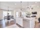 Bright, open kitchen with large island, stainless appliances, and hardwood floors at 12889 Hill Pine Rd, Midland, NC 28107
