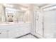 Bright main bathroom with double sinks, a glass-enclosed shower, and modern fixtures, offering a spa-like experience at 12889 Hill Pine Rd, Midland, NC 28107