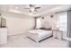 Serene main bedroom with tray ceiling, a ceiling fan, and elegant decor, creating a peaceful retreat at 12889 Hill Pine Rd, Midland, NC 28107