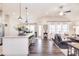 Spacious open-concept area featuring a kitchen island, dining area, and living room with a cohesive design at 12889 Hill Pine Rd, Midland, NC 28107