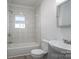 Bright bathroom with tub/shower combo and tiled wall at 1411 Roseland Dr, Lincolnton, NC 28092