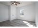 Bright bedroom with fresh paint, new vinyl floors, ceiling fan, and a window view at 1411 Roseland Dr, Lincolnton, NC 28092
