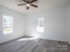 Bedroom featuring a ceiling fan, and windows overlooking the backyard at 1411 Roseland Dr, Lincolnton, NC 28092
