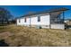 Side view of this charming home, featuring white siding, black roof, and well-maintained landscaping at 1411 Roseland Dr, Lincolnton, NC 28092