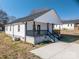 This well-maintained home features a classic white exterior and a welcoming front porch at 1411 Roseland Dr, Lincolnton, NC 28092
