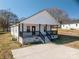 Charming home featuring a inviting front porch with black railings, perfect for enjoying the outdoors at 1411 Roseland Dr, Lincolnton, NC 28092