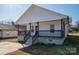 Charming home featuring a inviting front porch with black railings, perfect for enjoying the outdoors at 1411 Roseland Dr, Lincolnton, NC 28092