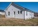 Rear view of the property showcasing its white siding, windows, and back door at 1411 Roseland Dr, Lincolnton, NC 28092