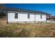 Side view of this charming home, featuring white siding, black roof, and well-maintained landscaping at 1411 Roseland Dr, Lincolnton, NC 28092