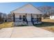 Charming home featuring a inviting front porch with black railings, perfect for enjoying the outdoors at 1411 Roseland Dr, Lincolnton, NC 28092