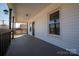 Charming front porch with black railings, white siding, and an inviting front door with glass details at 1411 Roseland Dr, Lincolnton, NC 28092