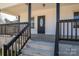 Charming front porch with black railings, concrete steps, and an inviting front door with glass details at 1411 Roseland Dr, Lincolnton, NC 28092