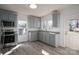 Eat-in kitchen featuring stainless steel appliances, gray cabinets, granite countertops, and vinyl floor at 1411 Roseland Dr, Lincolnton, NC 28092