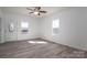Bright living room with a ceiling fan, wood-look flooring, and a decorative front door at 1411 Roseland Dr, Lincolnton, NC 28092