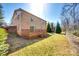 Backyard features a brick house, wood deck, and chain link fence at 1438 Plumstead Rd, Charlotte, NC 28216