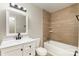Stylishly designed bathroom featuring a tiled shower/tub combo and updated vanity at 1438 Plumstead Rd, Charlotte, NC 28216