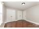 Bedroom features hardwood floors, neutral paint and multiple closets for ample storage at 1438 Plumstead Rd, Charlotte, NC 28216