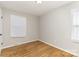 Bedroom has hardwood floors, light walls, and one window with blinds at 1438 Plumstead Rd, Charlotte, NC 28216