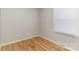 Bedroom with hardwood floors, light grey walls, one window with blinds at 1438 Plumstead Rd, Charlotte, NC 28216