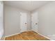 Bedroom features hardwood floors, light walls, and two paneled doors at 1438 Plumstead Rd, Charlotte, NC 28216