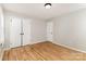 This bedroom features hardwood floors, neutral walls, and a double-door closet for ample storage at 1438 Plumstead Rd, Charlotte, NC 28216