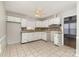 Bright kitchen featuring white cabinets, neutral countertops, tile backsplash, and tile flooring at 1438 Plumstead Rd, Charlotte, NC 28216