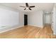 Spacious living room with hardwood flooring, modern ceiling fan, and ample natural light at 1438 Plumstead Rd, Charlotte, NC 28216