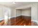 The inviting living room boasts lustrous hardwood floors and ample natural light at 1438 Plumstead Rd, Charlotte, NC 28216