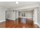 Spacious living room featuring polished hardwood floors and sliding glass door to a deck at 1438 Plumstead Rd, Charlotte, NC 28216