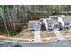 Aerial shot of a modern two-story home with a long driveway and lush landscaping in a quiet neighborhood at 16138 Aryshire Green Ct, Charlotte, NC 28273
