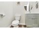 Powder room includes a modern sink, brushed nickel hardware, and a round mirror at 16138 Aryshire Green Ct, Charlotte, NC 28273
