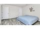 This bedroom features a bed, grey wood flooring, and two doors at 16138 Aryshire Green Ct, Charlotte, NC 28273