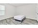 This bedroom features a bed, grey wood flooring, and natural light from the window at 16138 Aryshire Green Ct, Charlotte, NC 28273