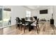 Dining room features hardwood floors, access to the patio, and a fireplace at 16138 Aryshire Green Ct, Charlotte, NC 28273