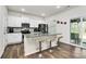 Modern kitchen island featuring granite countertops and stainless steel appliances with a sliding door to a patio at 16138 Aryshire Green Ct, Charlotte, NC 28273